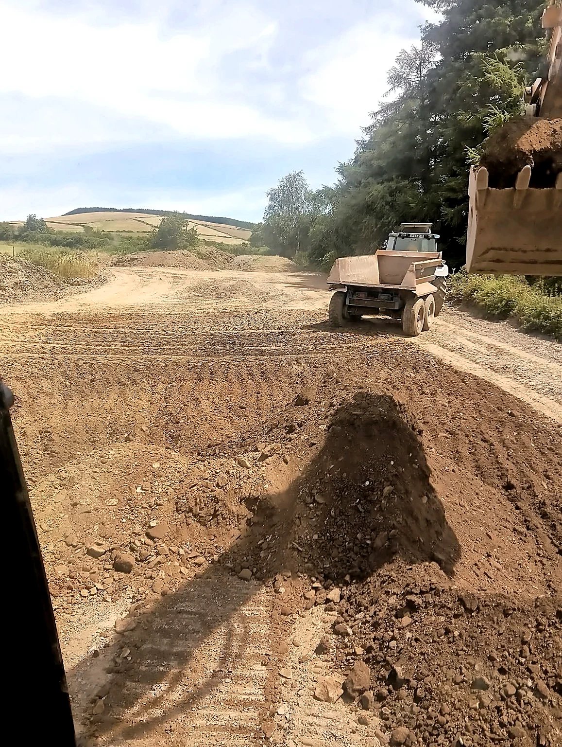 Site dumper moving material during groundworks